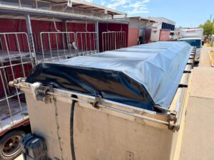 Black wind out truck tarp on a white truck