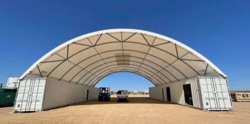 A PVC tarp covering two shipping containers