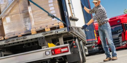 A man following the Australian Load Restraint Guidelines